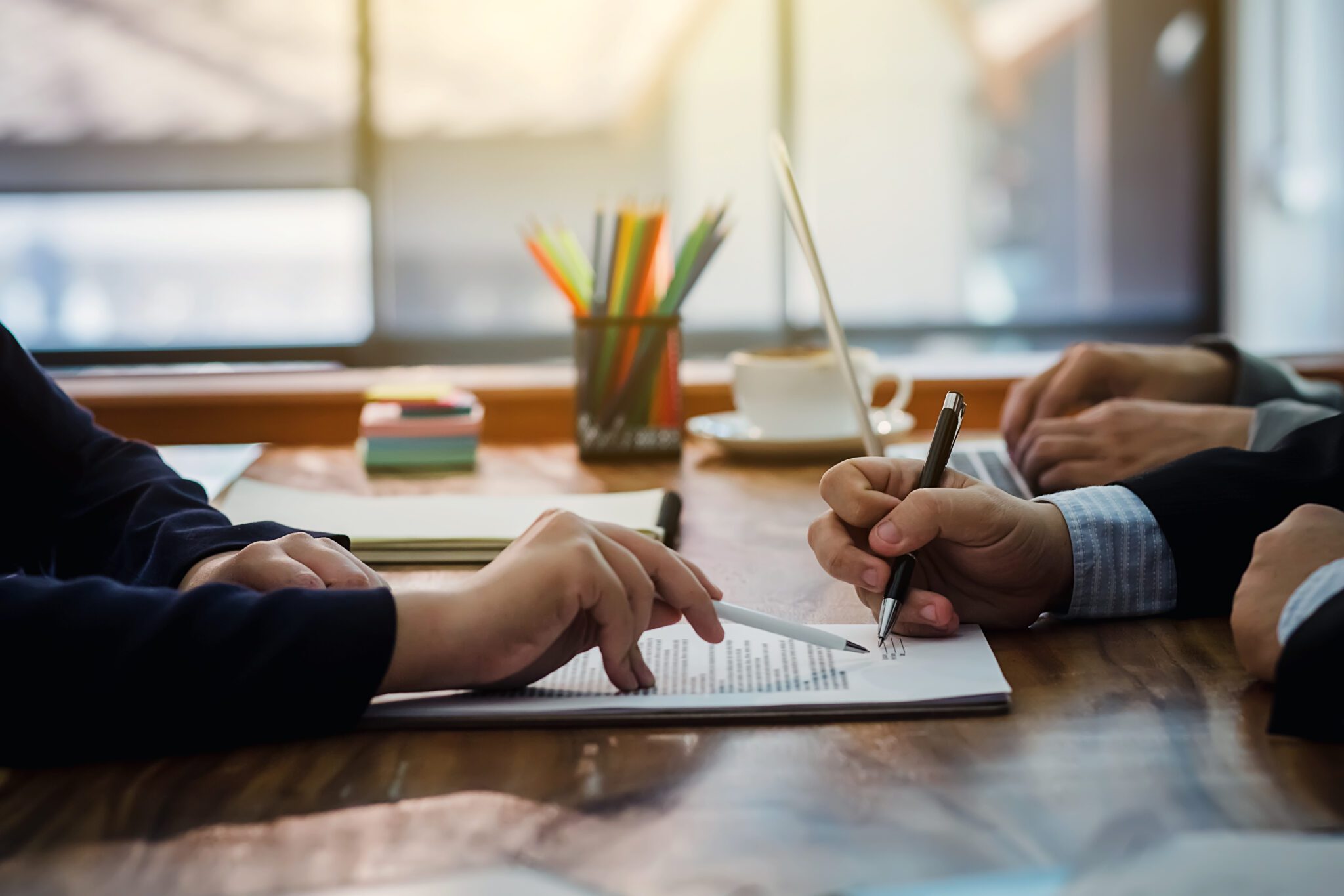 Two people collaborating and writing notes at a desk.