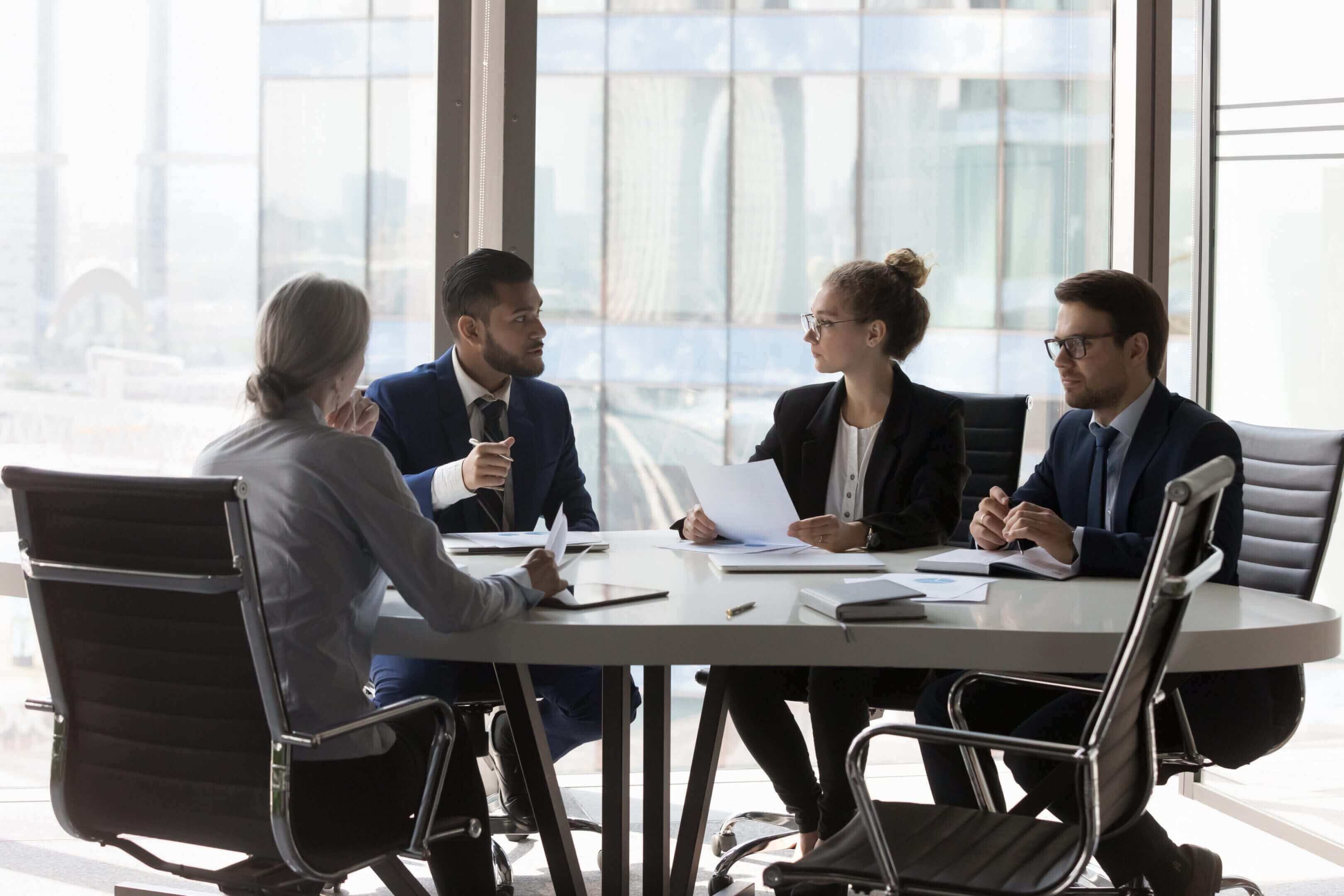 Four professionals having a business meeting in a modern office.