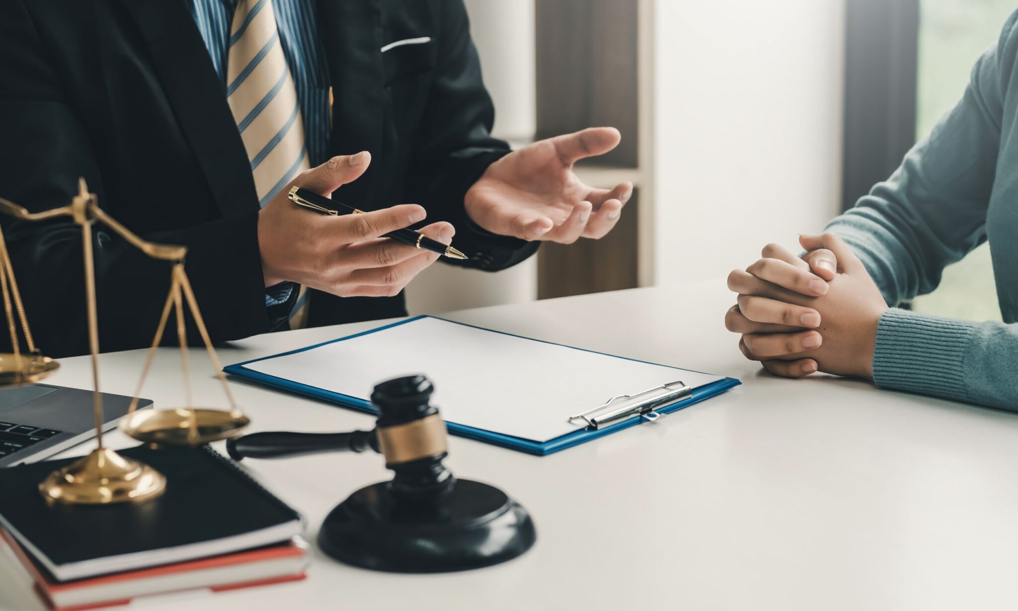 Lawyer consulting client with legal documents.