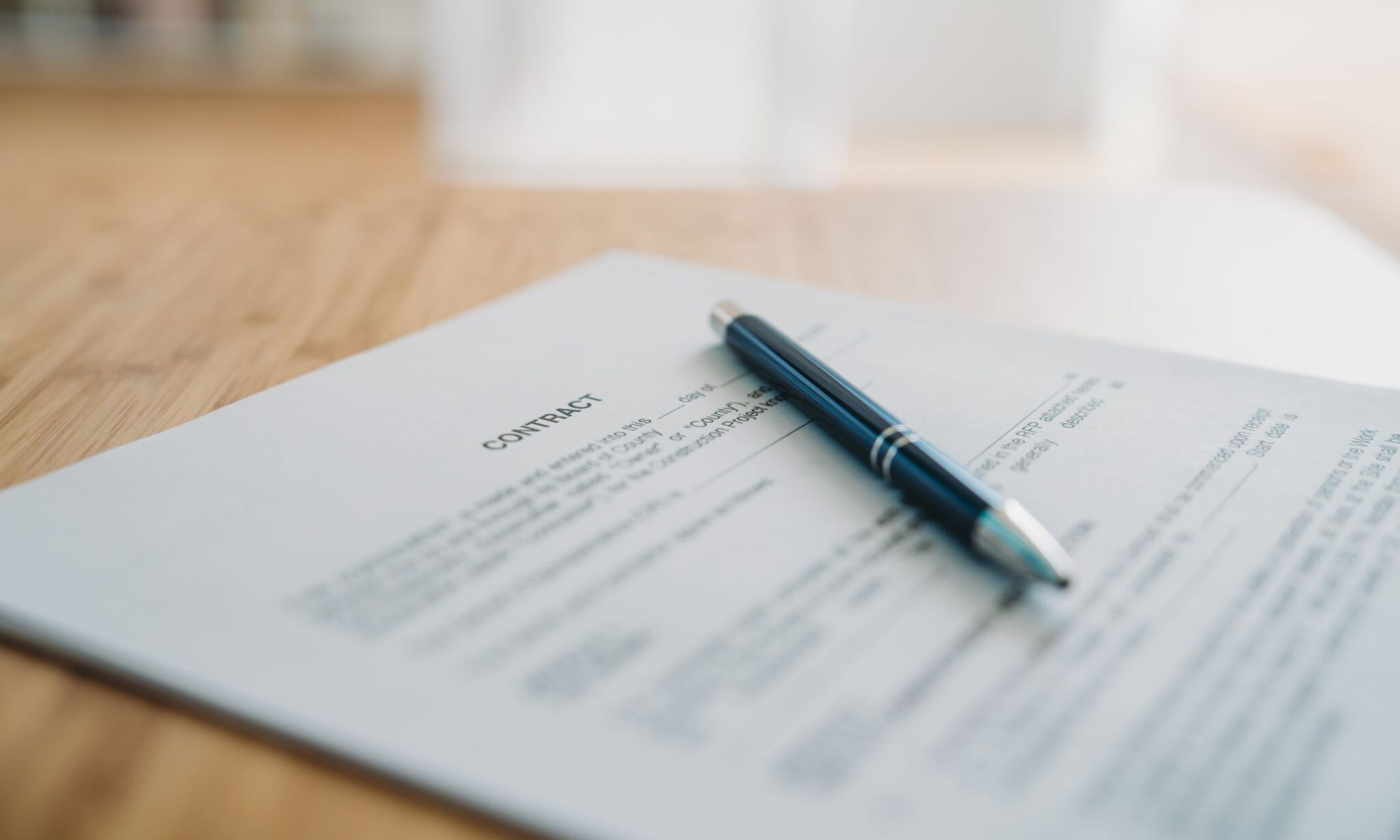 Contract document with a pen on table.