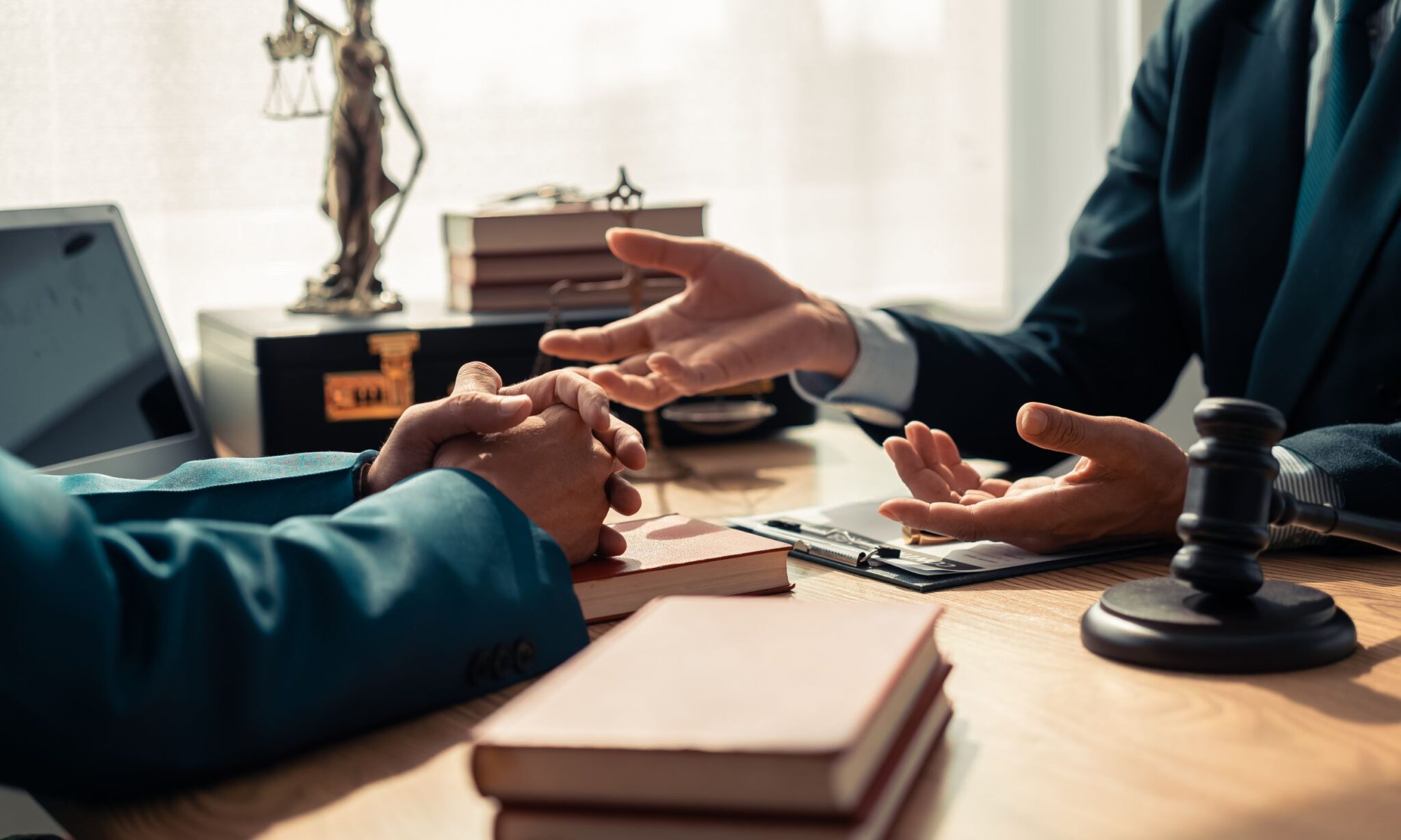 Two people discussing at a lawyer's desk.