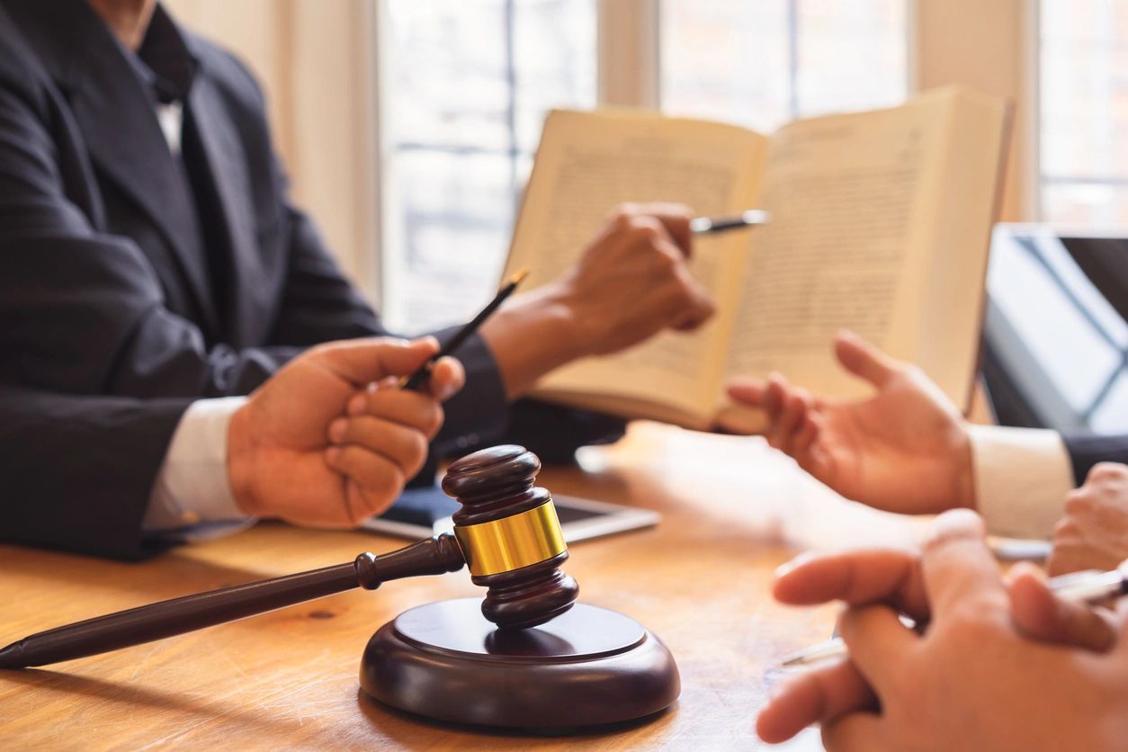 Gavel on table during legal discussion meeting.