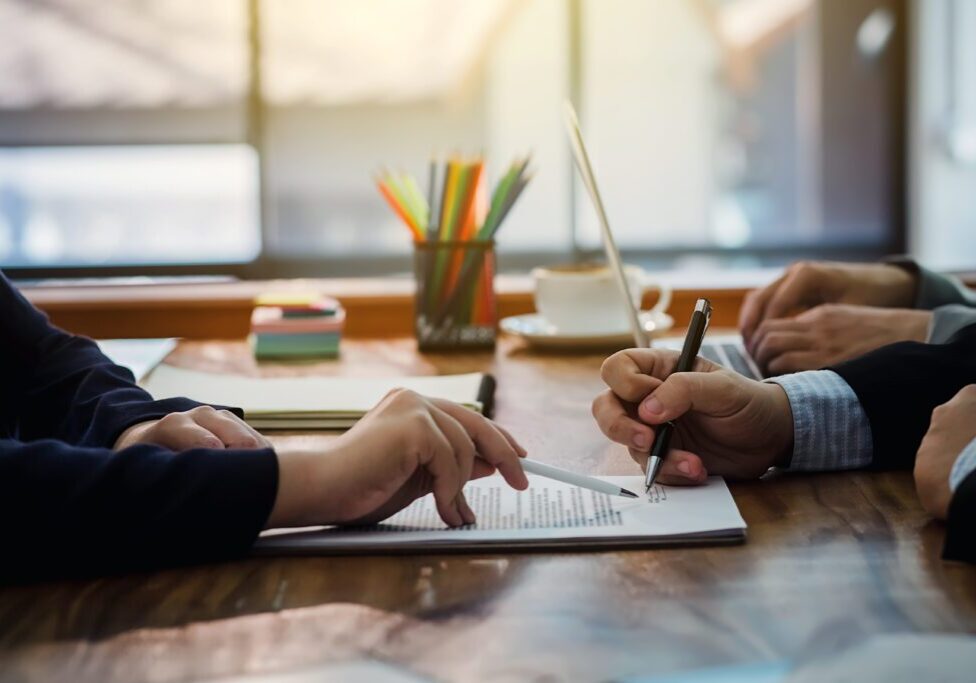 Two people collaborating and writing notes at a desk.