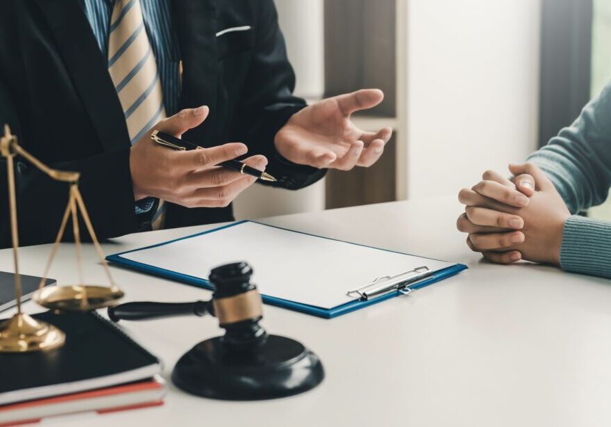 Lawyer consulting client with legal documents.