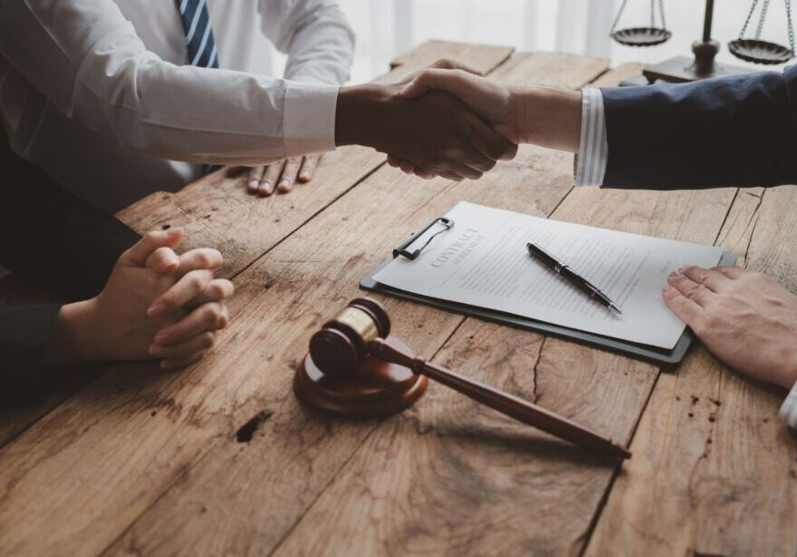 Handshake over legal document and gavel.
