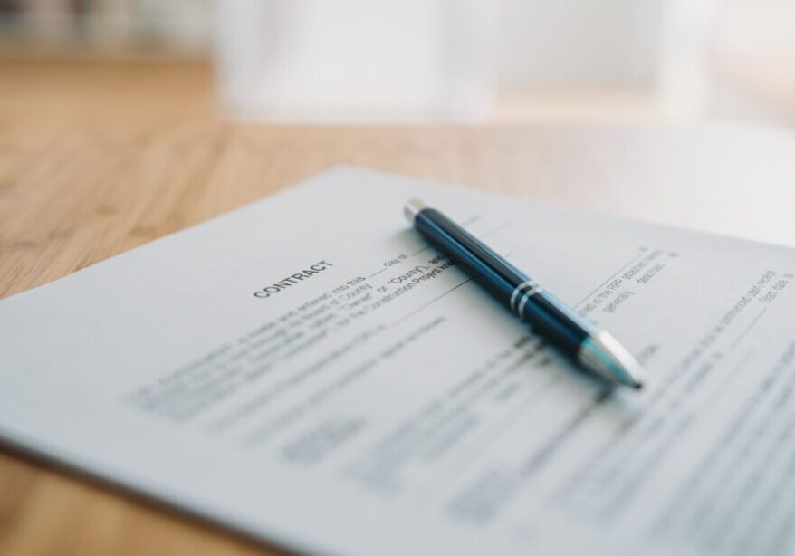 Contract document with a pen on table.
