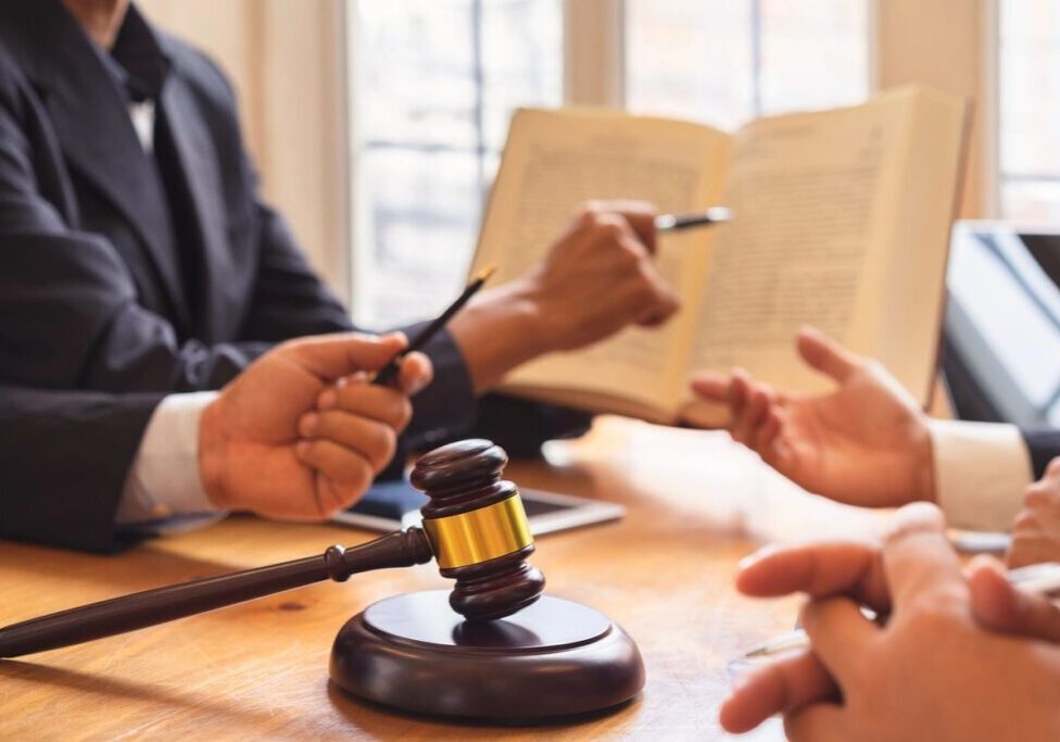 Gavel on table during legal discussion meeting.